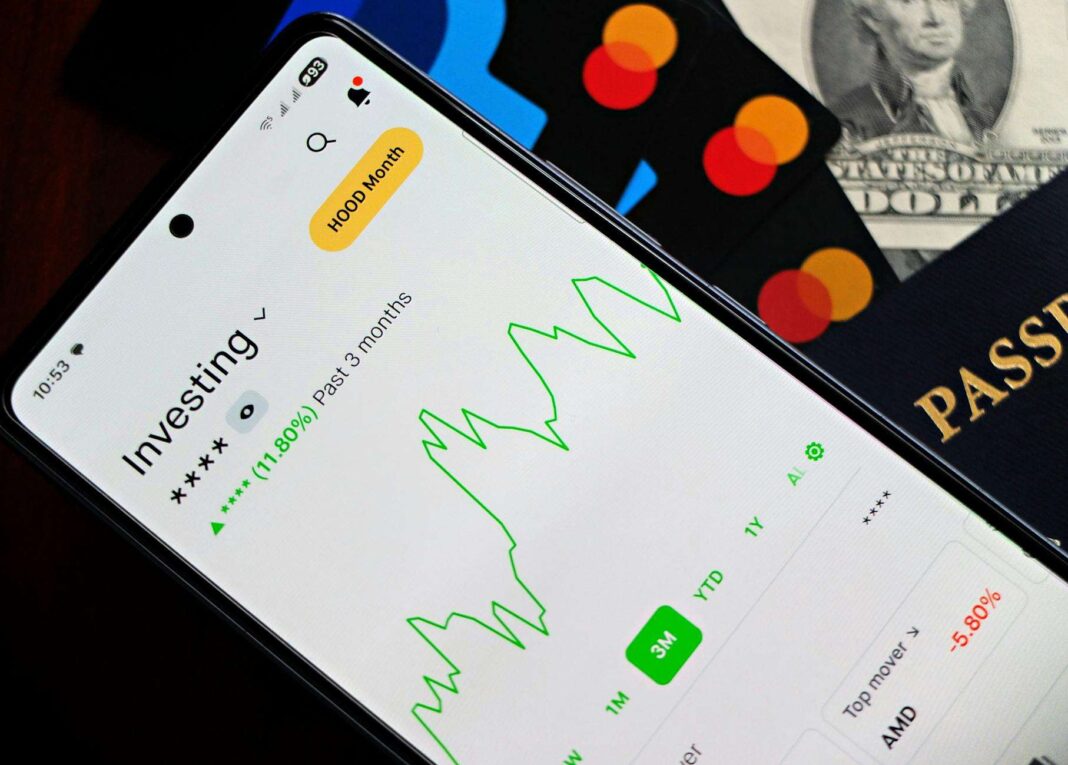 Smartphone screens showing graphs and cryptocurrency portfolio tracking apps.